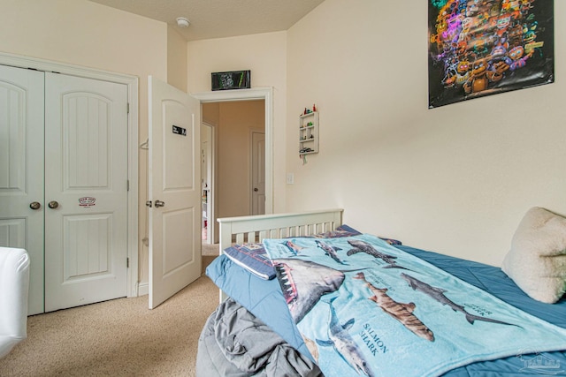 bedroom featuring a closet and light colored carpet