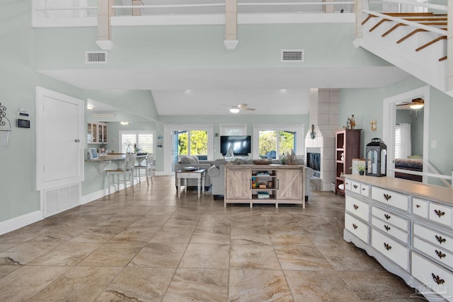 kitchen featuring high vaulted ceiling, plenty of natural light, white cabinets, and ceiling fan