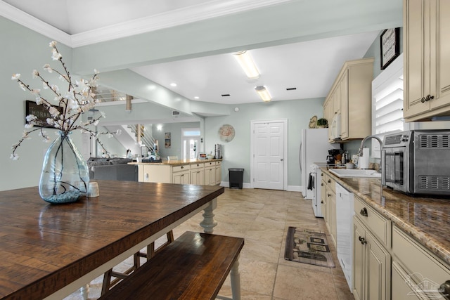 tiled dining area featuring sink and crown molding