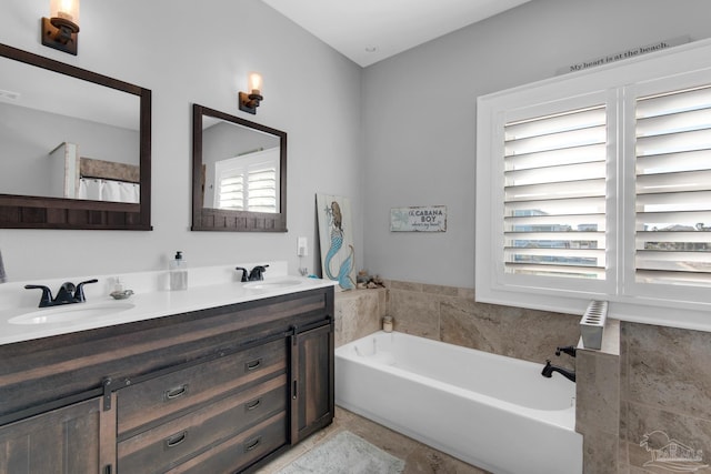 bathroom with a tub to relax in and vanity