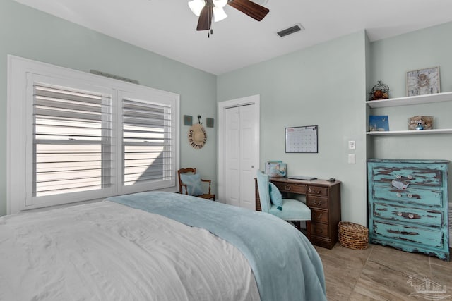 bedroom with ceiling fan and a closet