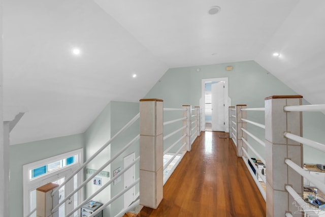 hall with lofted ceiling and dark hardwood / wood-style flooring