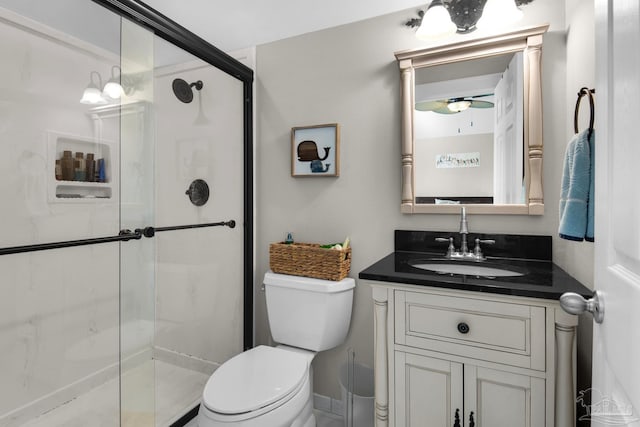 bathroom featuring vanity, toilet, and an enclosed shower