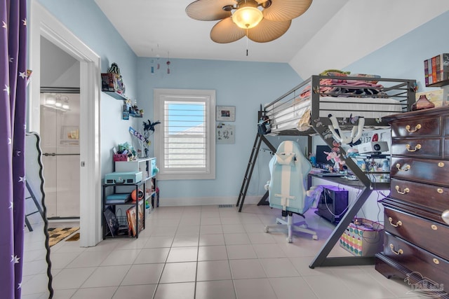 bedroom with ceiling fan, light tile patterned floors, and lofted ceiling