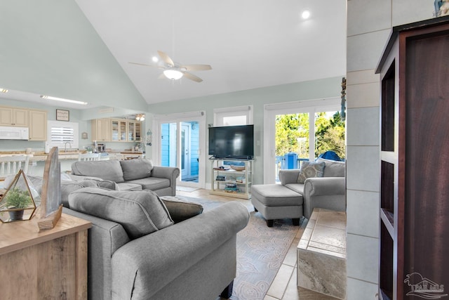 living room featuring ceiling fan, light tile patterned flooring, and high vaulted ceiling