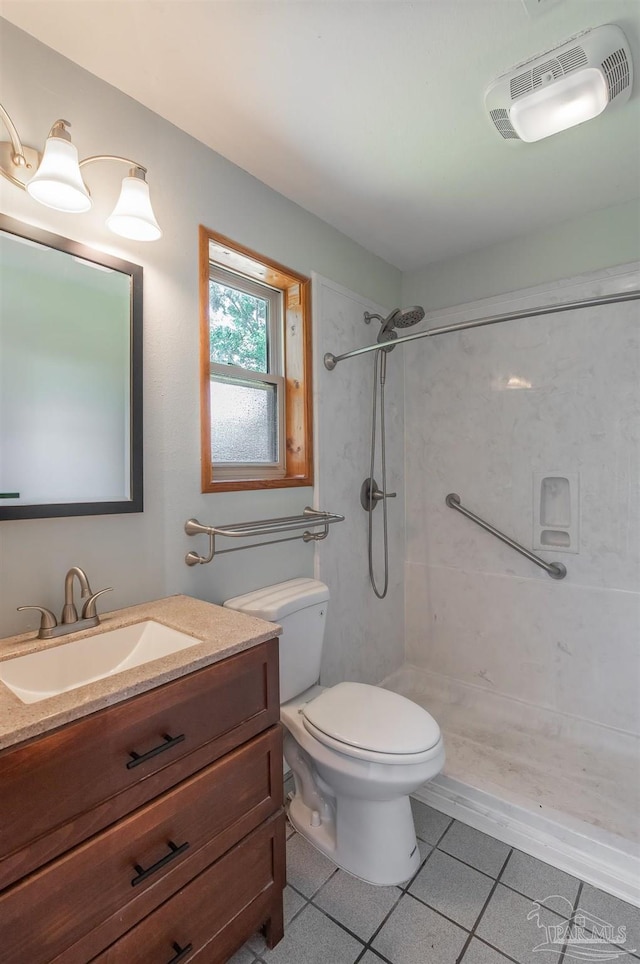7026 Balboa Dr, Pensacola, FL 32526 - bathroom with a tile shower, vanity, and tile patterned flooring