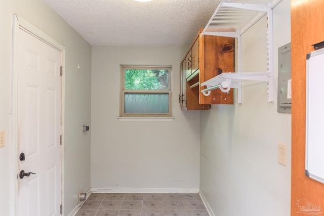 7026 Balboa Dr, Pensacola, FL 32526 - laundry room featuring a textured ceiling and baseboards