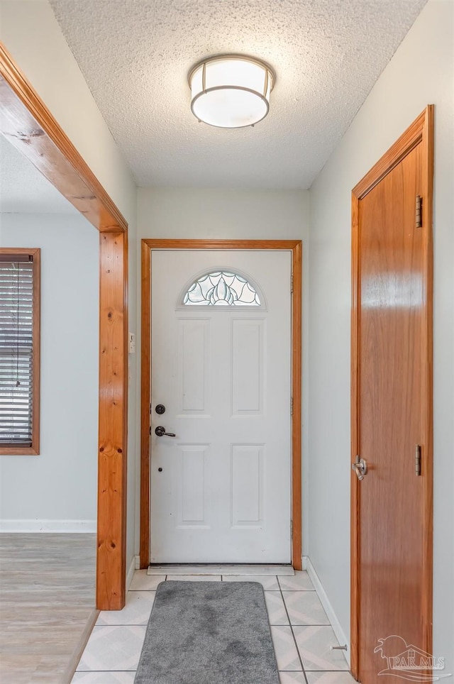 7026 Balboa Dr, Pensacola, FL 32526 - foyer featuring a textured ceiling, light tile patterned floors, and healthy amount of natural light