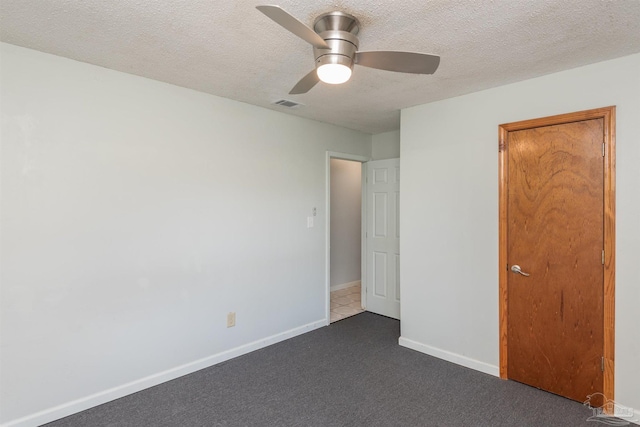 7026 Balboa Dr, Pensacola, FL 32526 - unfurnished bedroom featuring dark carpet, a textured ceiling, and a ceiling fan