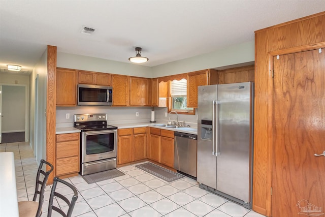 7026 Balboa Dr, Pensacola, FL 32526 - kitchen with stainless steel appliances, light countertops, and brown cabinets