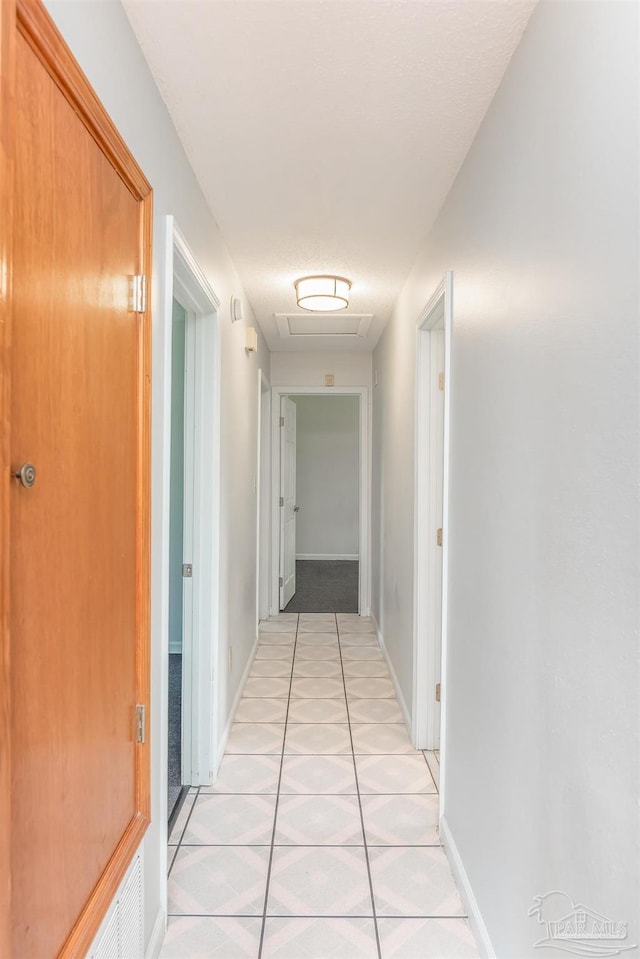 7026 Balboa Dr, Pensacola, FL 32526 - hallway with light tile patterned flooring and baseboards