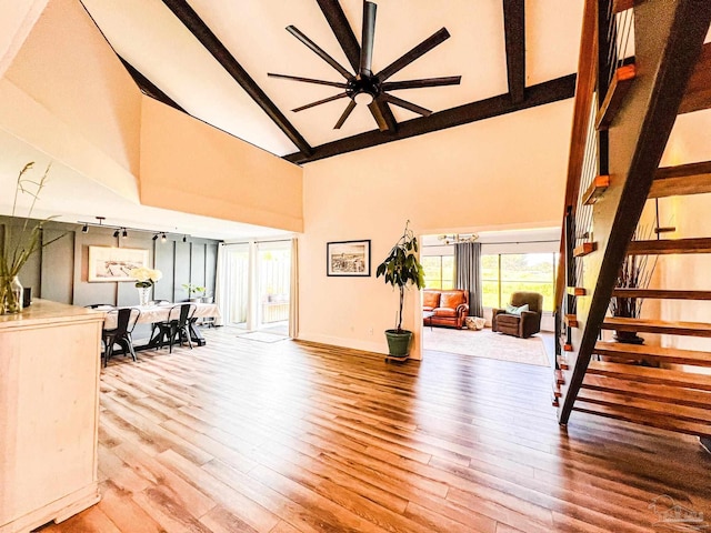 4718 Huron Dr, Pensacola, FL 32507 - living area with high vaulted ceiling, wood finished floors, beam ceiling, ceiling fan, and baseboards