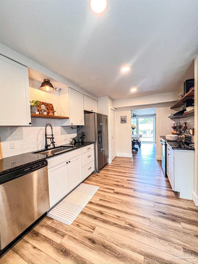 4718 Huron Dr, Pensacola, FL 32507 - kitchen featuring open shelves, appliances with stainless steel finishes, a sink, dark countertops, and recessed lighting
