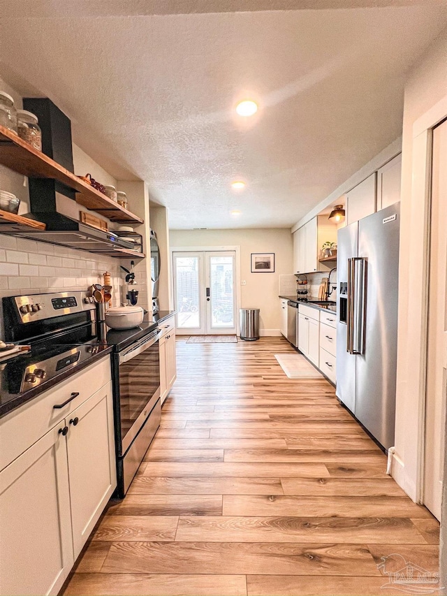 4718 Huron Dr, Pensacola, FL 32507 - kitchen with stainless steel appliances, open shelves, dark countertops, french doors, and light wood-type flooring