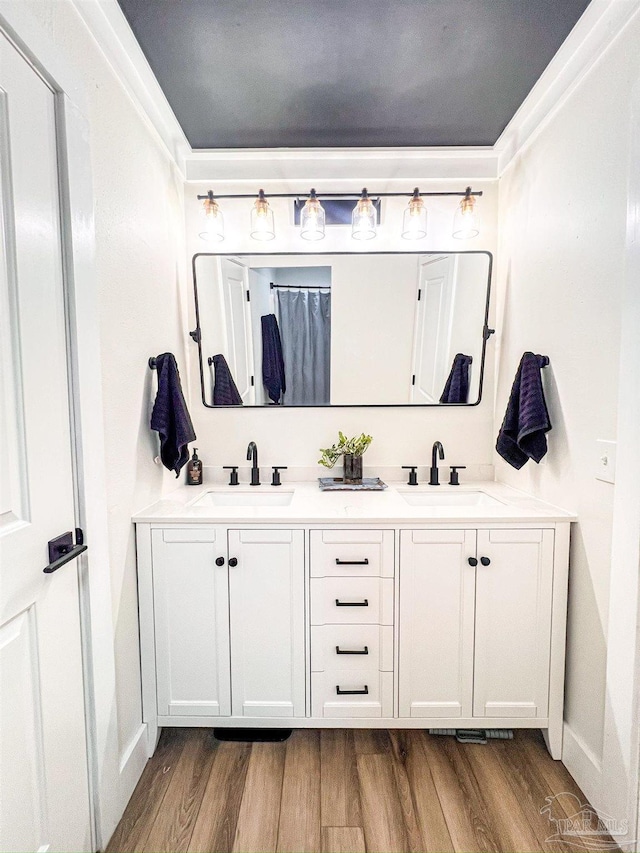 4718 Huron Dr, Pensacola, FL 32507 - bathroom featuring wood finished floors, double vanity, and baseboards