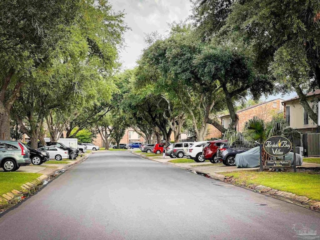 4718 Huron Dr, Pensacola, FL 32507 - view of asphalt road featuring curbs and a residential view