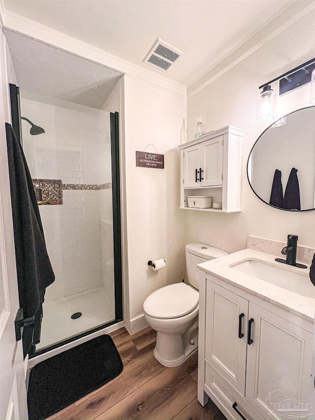 4718 Huron Dr, Pensacola, FL 32507 - full bath featuring crown molding, wood finished floors, a shower stall, vanity, and toilet