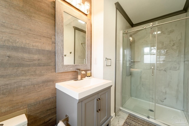 bathroom with vanity, a shower with door, and ornamental molding