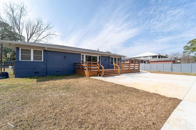 back of house with a patio, a yard, and a deck