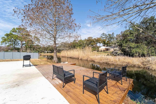 wooden terrace featuring a water view