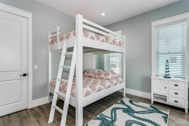 bedroom with recessed lighting, wood finished floors, and baseboards