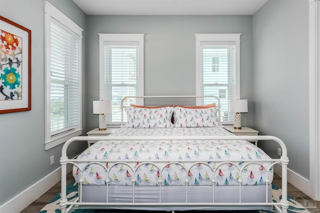 bedroom with baseboards and wood finished floors