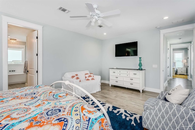 bedroom featuring light wood-style floors, baseboards, visible vents, and ceiling fan