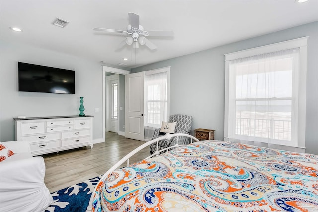 bedroom featuring ceiling fan, recessed lighting, wood finished floors, visible vents, and baseboards