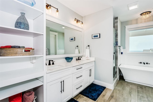 full bath featuring a sink, a shower stall, and wood finished floors