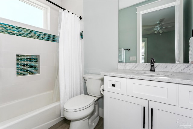 full bath with shower / tub combo with curtain, toilet, ceiling fan, vanity, and wood finished floors