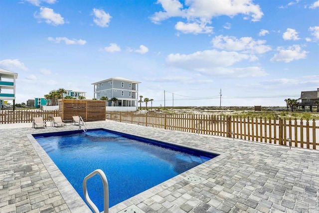 view of pool featuring a patio area, a fenced backyard, and a fenced in pool