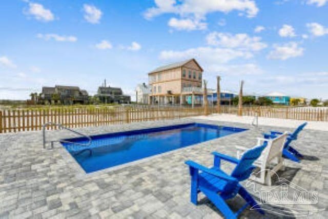 view of swimming pool featuring a patio area, fence, and a fenced in pool