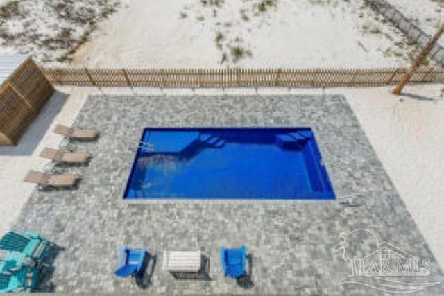 view of swimming pool with a fenced backyard