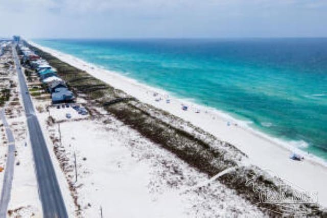 birds eye view of property with a water view and a view of the beach