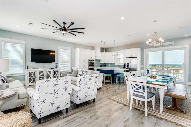 living area with a healthy amount of sunlight, recessed lighting, and light wood-style floors