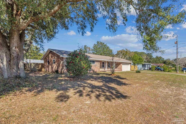 view of front of property with a garage and a front yard