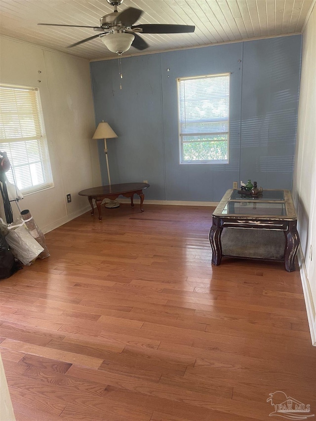 sitting room with wood ceiling, baseboards, a ceiling fan, and wood finished floors