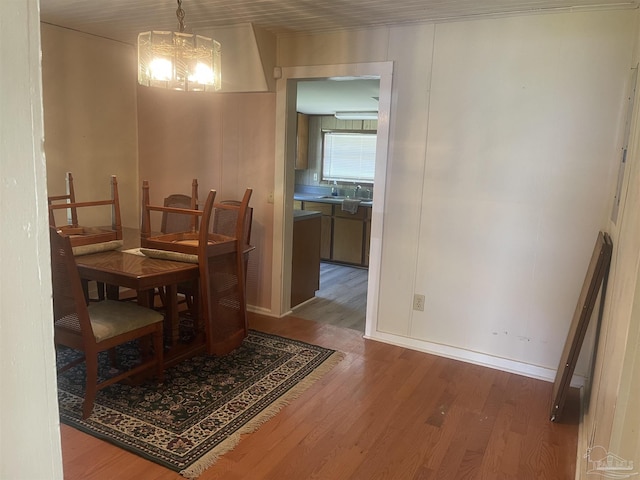 dining area featuring a chandelier and wood finished floors