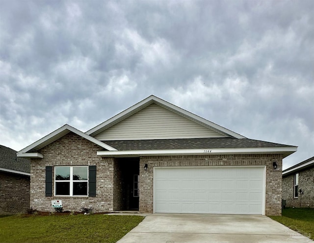 1644 Slate Dr, Cantonment, FL 32533 - view of front of home with brick siding, driveway, and a front lawn