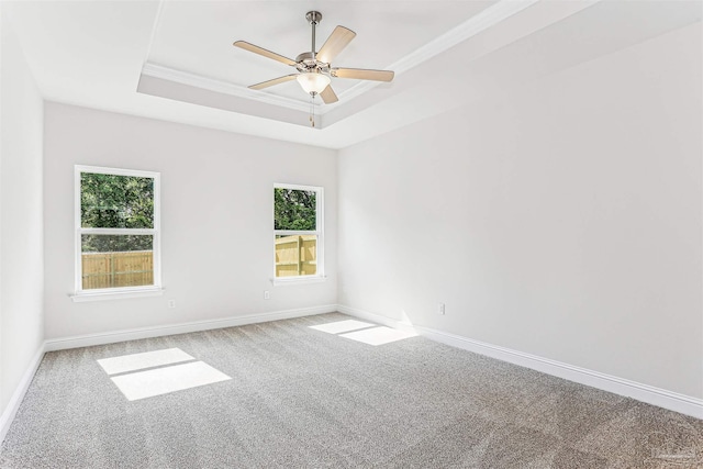 1644 Slate Dr, Cantonment, FL 32533 - carpeted empty room with a tray ceiling, plenty of natural light, ceiling fan, crown molding, and baseboards