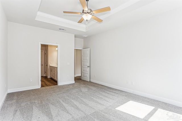 1644 Slate Dr, Cantonment, FL 32533 - unfurnished bedroom featuring a tray ceiling, carpet, baseboards, ornamental molding, and ensuite bathroom