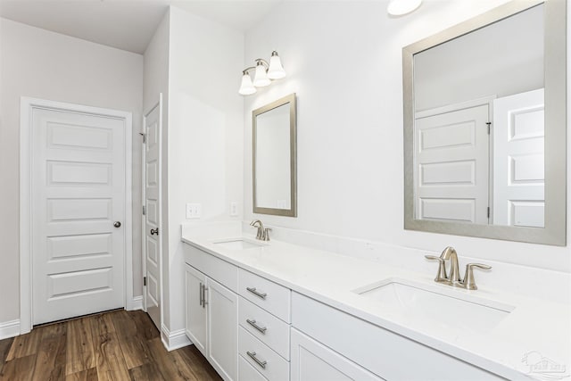 1644 Slate Dr, Cantonment, FL 32533 - bathroom featuring wood finished floors, double vanity, and baseboards
