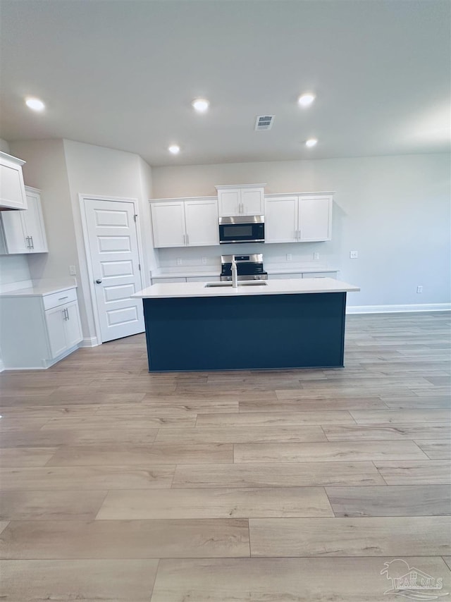 1644 Slate Dr, Cantonment, FL 32533 - kitchen with appliances with stainless steel finishes, light wood-style flooring, recessed lighting, baseboards, and light countertops