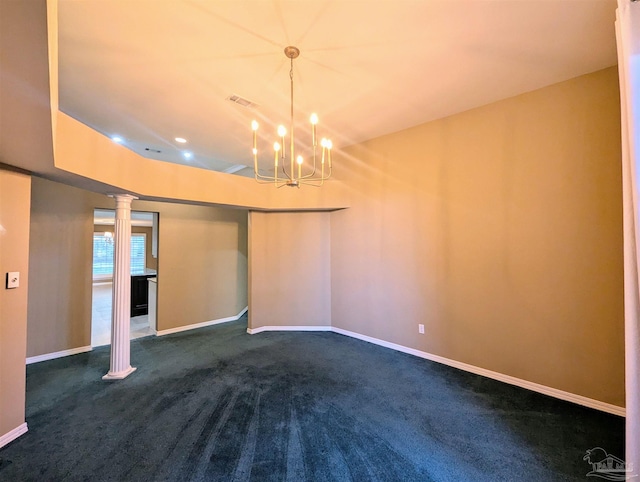 unfurnished room with an inviting chandelier, carpet floors, and ornate columns