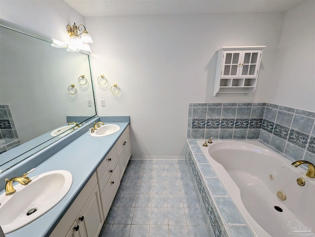 bathroom with tile patterned floors, vanity, and tiled tub