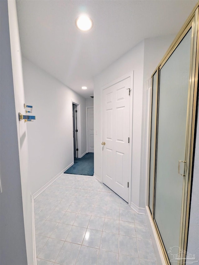 corridor featuring light tile patterned floors