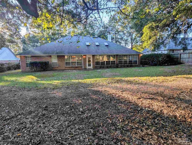 back of house with a lawn