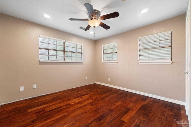 spare room with ceiling fan and dark hardwood / wood-style floors