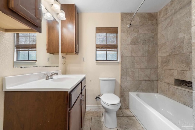 full bathroom featuring vanity, toilet, and tiled shower / bath