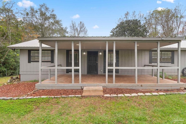 rear view of house featuring a yard